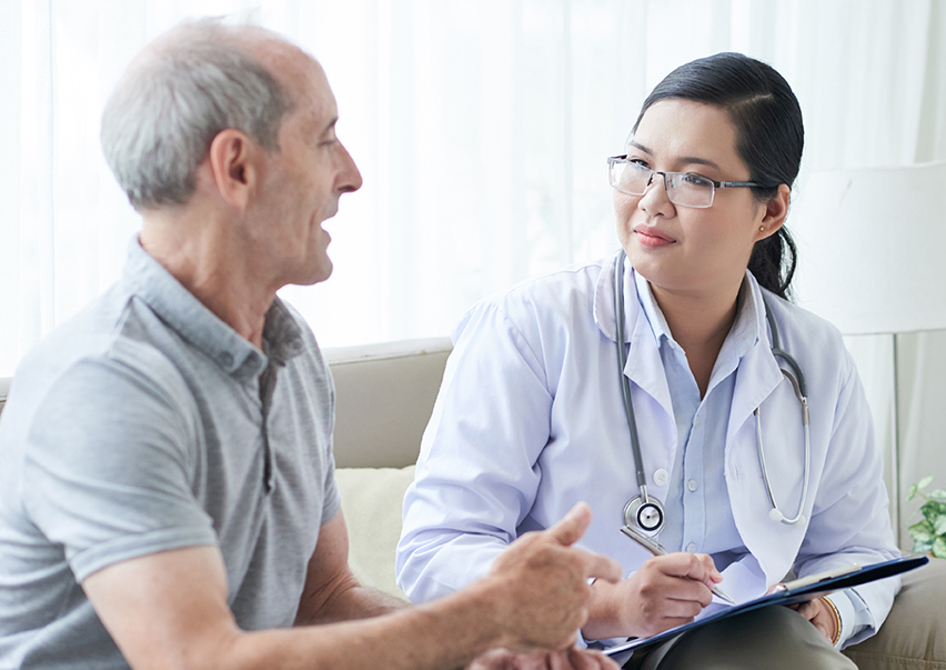 Doctor with senior patient at home